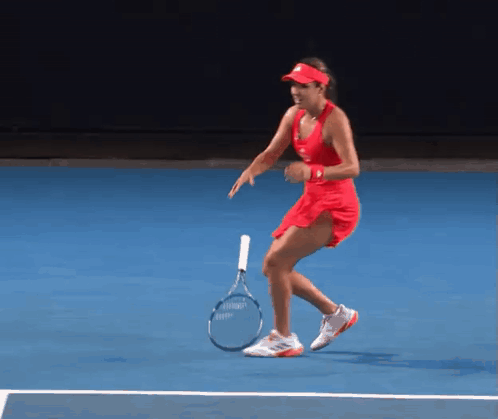 Woman in Red Dress Holding Tennis Racquet
