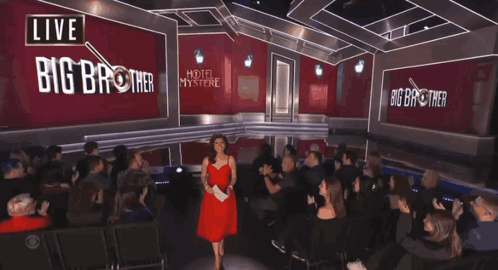 Woman in Red Dress in Front of Big Brother Sign
