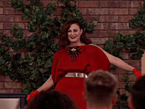 Woman In Red Dress In Front Of Crowd GIF