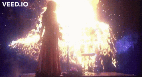 Woman in Red Dress in Front of Fire