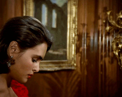 Woman in Red Dress in Front of Painting