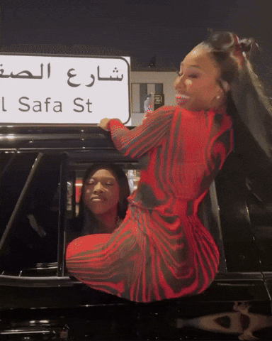 Woman in Red Dress in Front of Safa St Sign