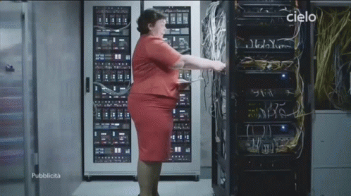 Woman in Red Dress in Front of Server Rack With Cielo