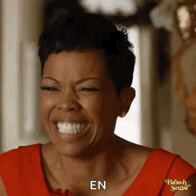 Woman in Red Dress Laughing and Saying En