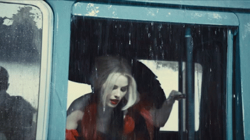 Woman in Red Dress Looking Out Window