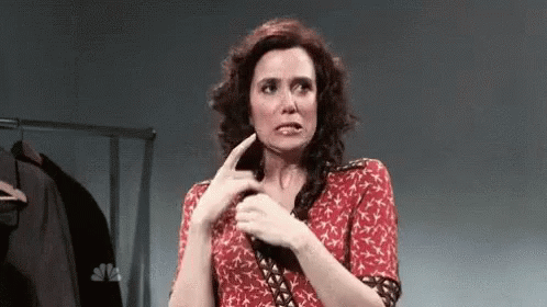 Woman in Red Dress Making Funny Face with Finger