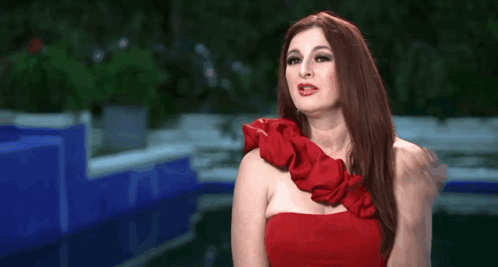 Woman In Red Dress Making Gesture GIF