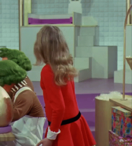 Woman in Red Dress Next to Man in Crocodile Outfit