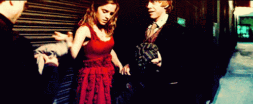 Woman in Red Dress Next to Man in Suit