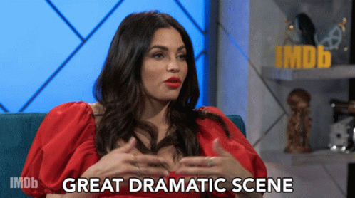 Woman in Red Dress on Blue Couch Saying Great Dramatic Scene