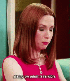 Woman in Red Dress on Blue Couch Says Being an Adult Is Terrible