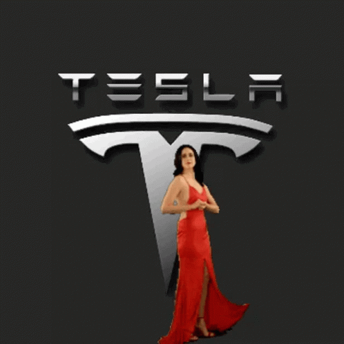 Woman in Red Dress Posing in Front of Tesla Logo
