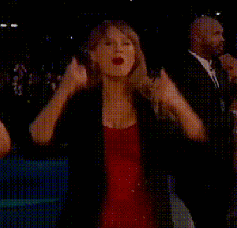 Woman In Red Dress Raising Fist GIF