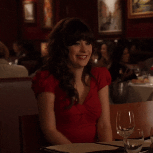 Woman in Red Dress Sitting at Table