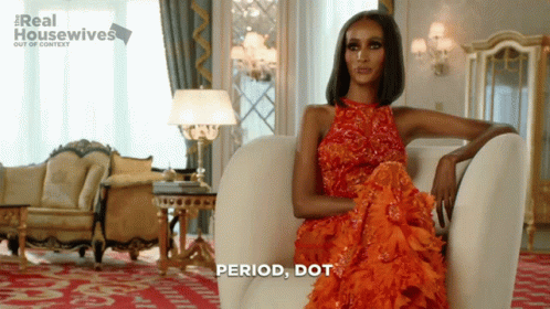 Woman In Red Dress Sitting With Period Dot GIF