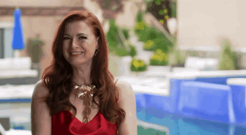 Woman In Red Dress Smiling By Swimming Pool GIF