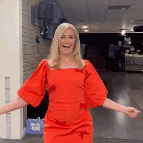 Woman In Red Dress Standing By Sewing Supply Bag GIF