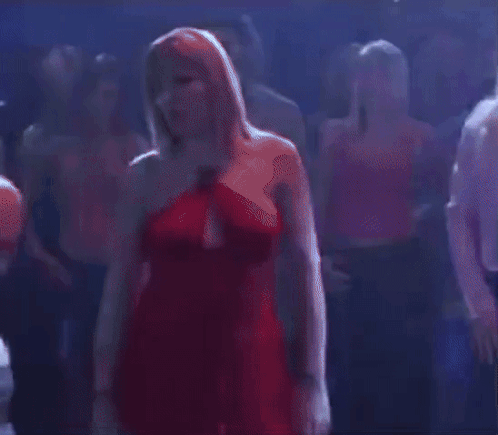 Woman in Red Dress Standing in Crowd