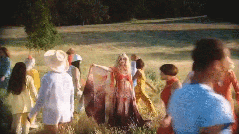 Woman in Red Dress Surrounded by People