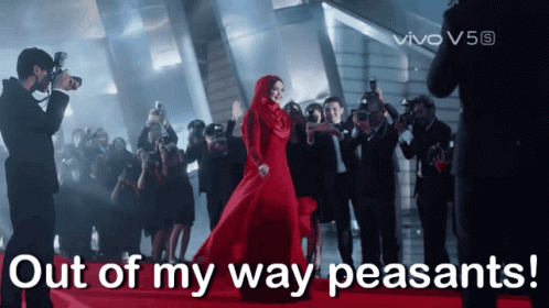 Woman in Red Dress Surrounded by Photographers Saying Out of My Way Peasants