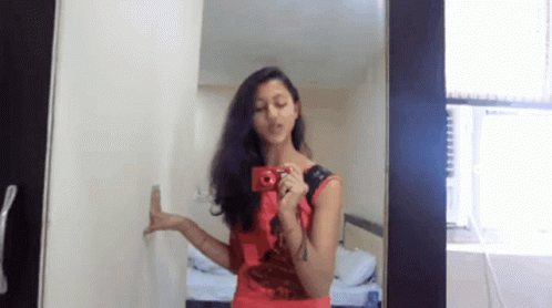 Woman in Red Dress Taking Mirror Selfie