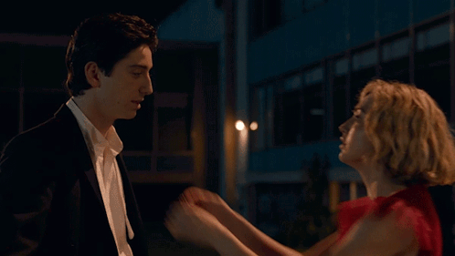 Woman in Red Dress Touching Man in Suit