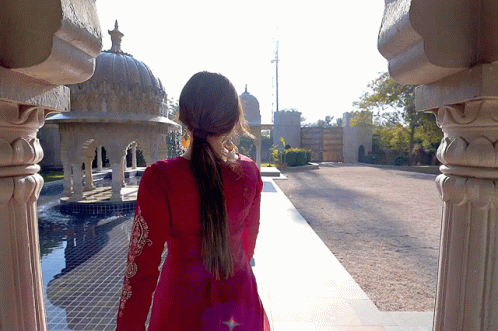 Woman in Red Dress Walking by Building