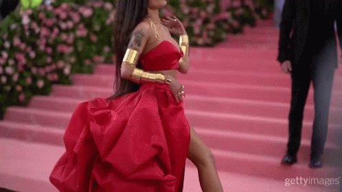 Woman in Red Dress Walking Down Pink Staircase