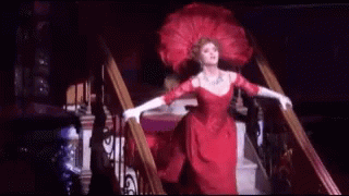 Woman in Red Dress Walking Down Stairs