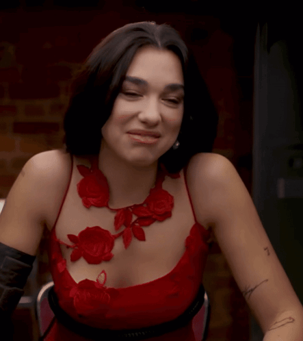 Woman in Red Dress With Arm Tattoo Saying I