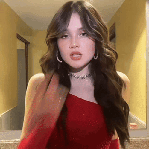 Woman In Red Dress With Choker Looking At Camera GIF