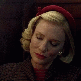 Woman in Red Hat and Plaid Jacket Looking at Camera
