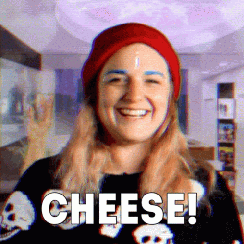 Woman in Red Hat and Skull Shirt Saying Cheese
