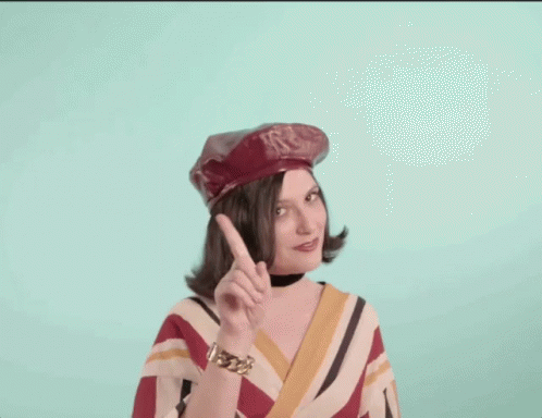 Woman in Red Hat and Striped Shirt Pointing Up