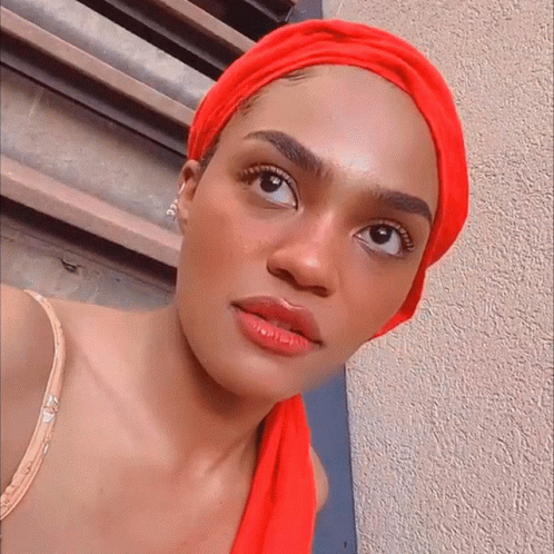 Woman in Red Head Scarf Looking Sideways