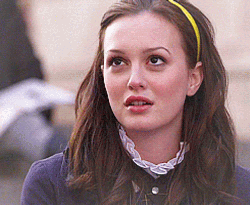 Woman In Red Headband Talking To Another GIF