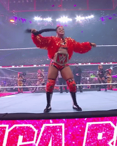 Woman in Red Holding Whip Wrestling Ring Raw