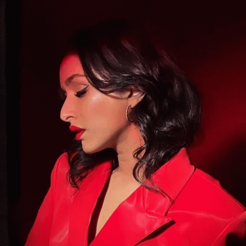 Woman in Red Jacket and Earrings Looking Down