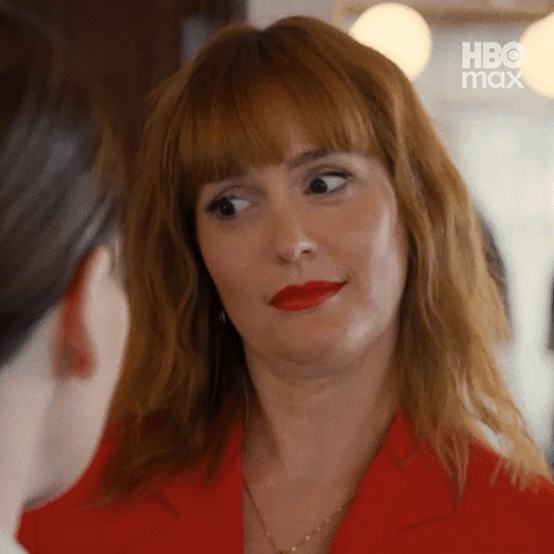 Woman in Red Jacket and Red Lipstick Looking at Woman
