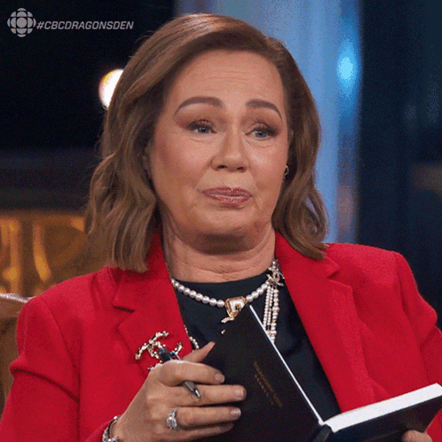 Woman In Red Jacket Holding Book And Pen GIF