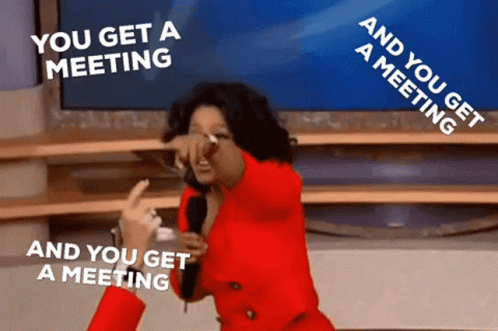 Woman in Red Jacket Holding Microphone Saying You Get a Meeting