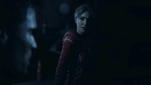 Woman In Red Jacket In Dark Room GIF