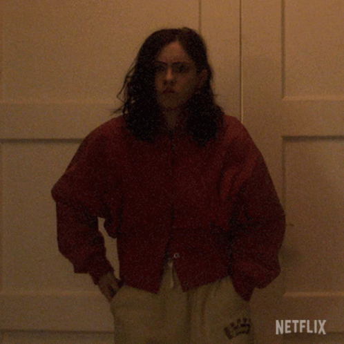 Woman in Red Jacket in Front of Netflix Door