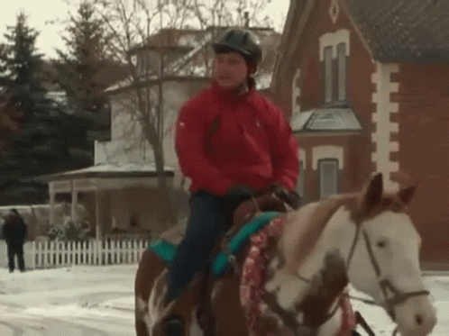 Woman in Red Jacket Riding Horse