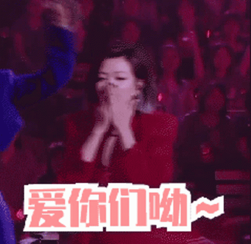Woman In Red Jacket Screaming In Front Of Crowd With Chinese Writing GIF