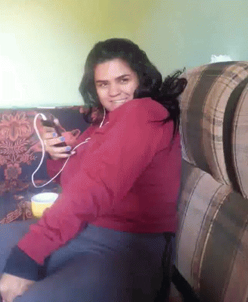 Woman in Red Jacket Sitting on Couch