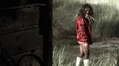 Woman in Red Jacket Standing in Grass