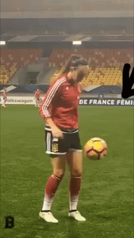 Woman in Red Jersey Kicking Soccer Ball