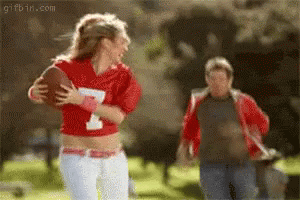 Woman In Red Jersey Number 1 Holding Football GIF