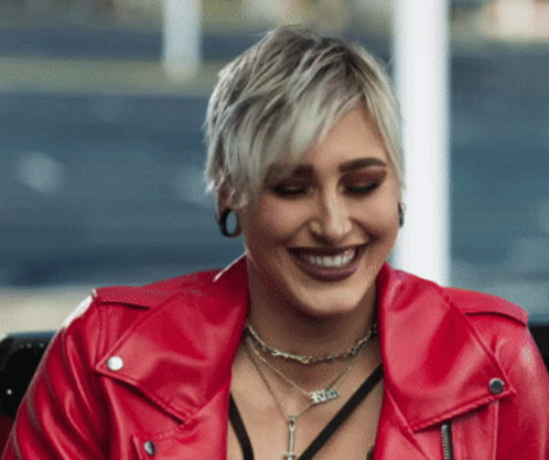 Woman in Red Leather Jacket With Faith Necklace Smiling